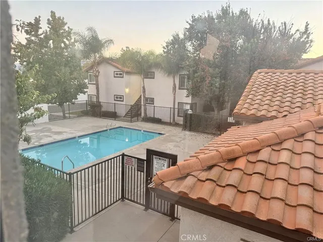 a view of a house with backyard and sitting area