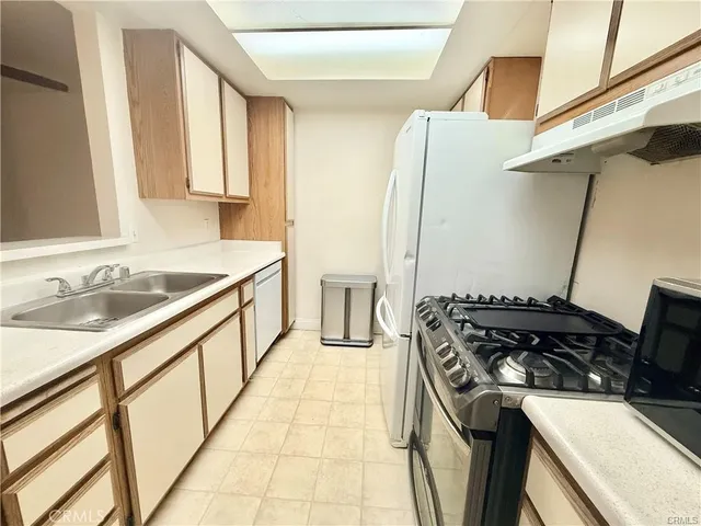 a kitchen that has a sink and a stove