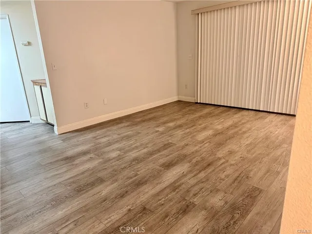 an empty room with wooden floor