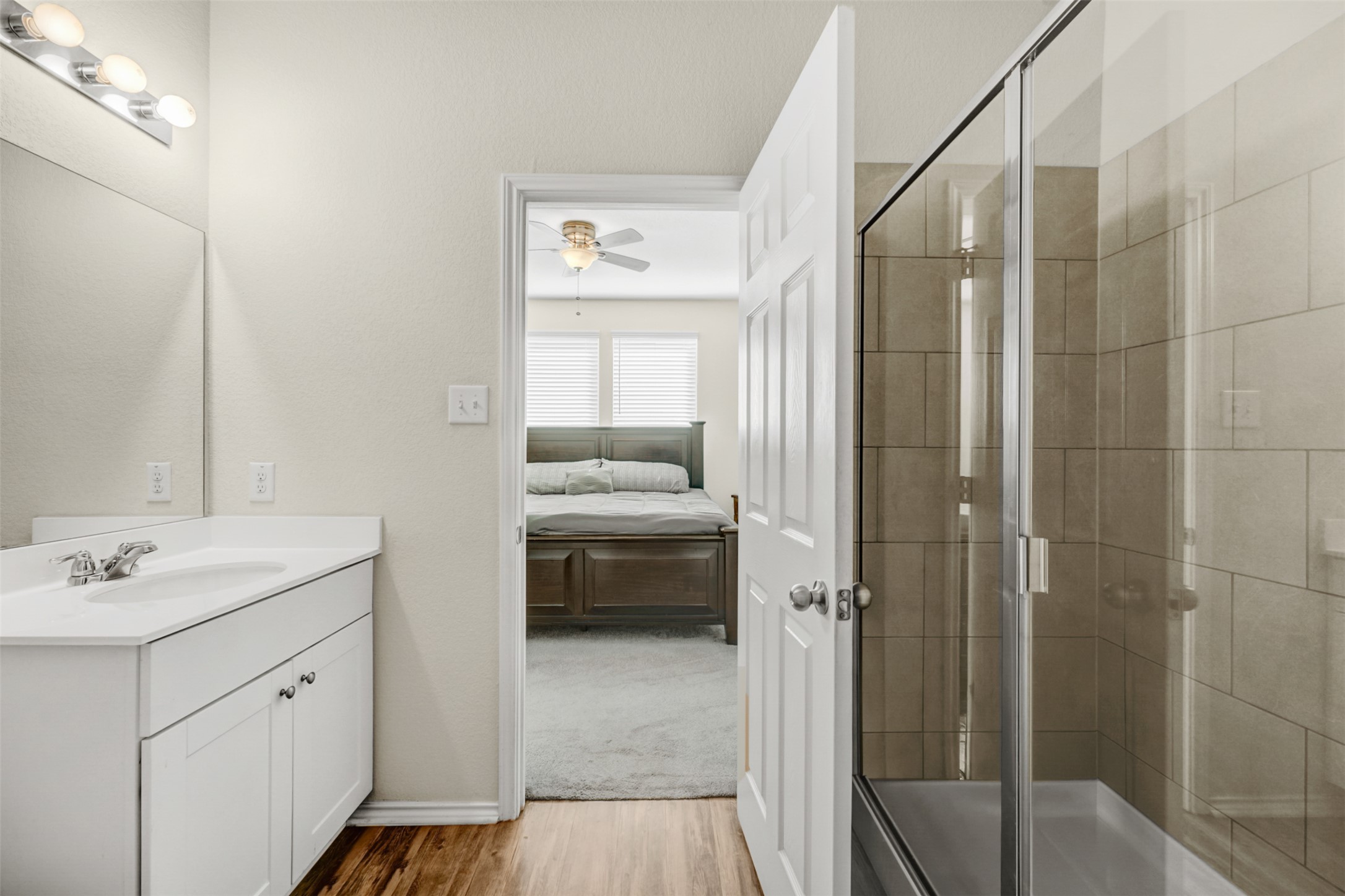 213 Ibis Falls Loop Jarrell, TX 76537 - Photo 18 of 37 A well-appointed bathroom offers a convenient transition to a serene primary bedroom.