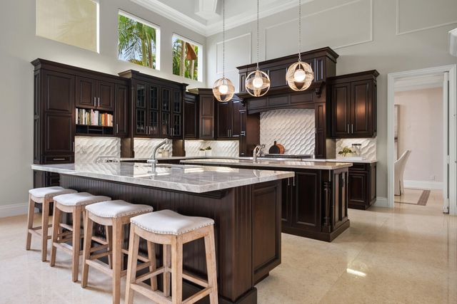 a kitchen with a cabinets and chairs