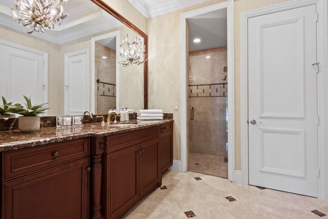 a large bathroom with a large mirror vanity sink and bathtub