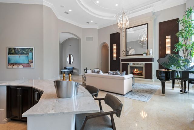 a living room with fireplace furniture and a chandelier