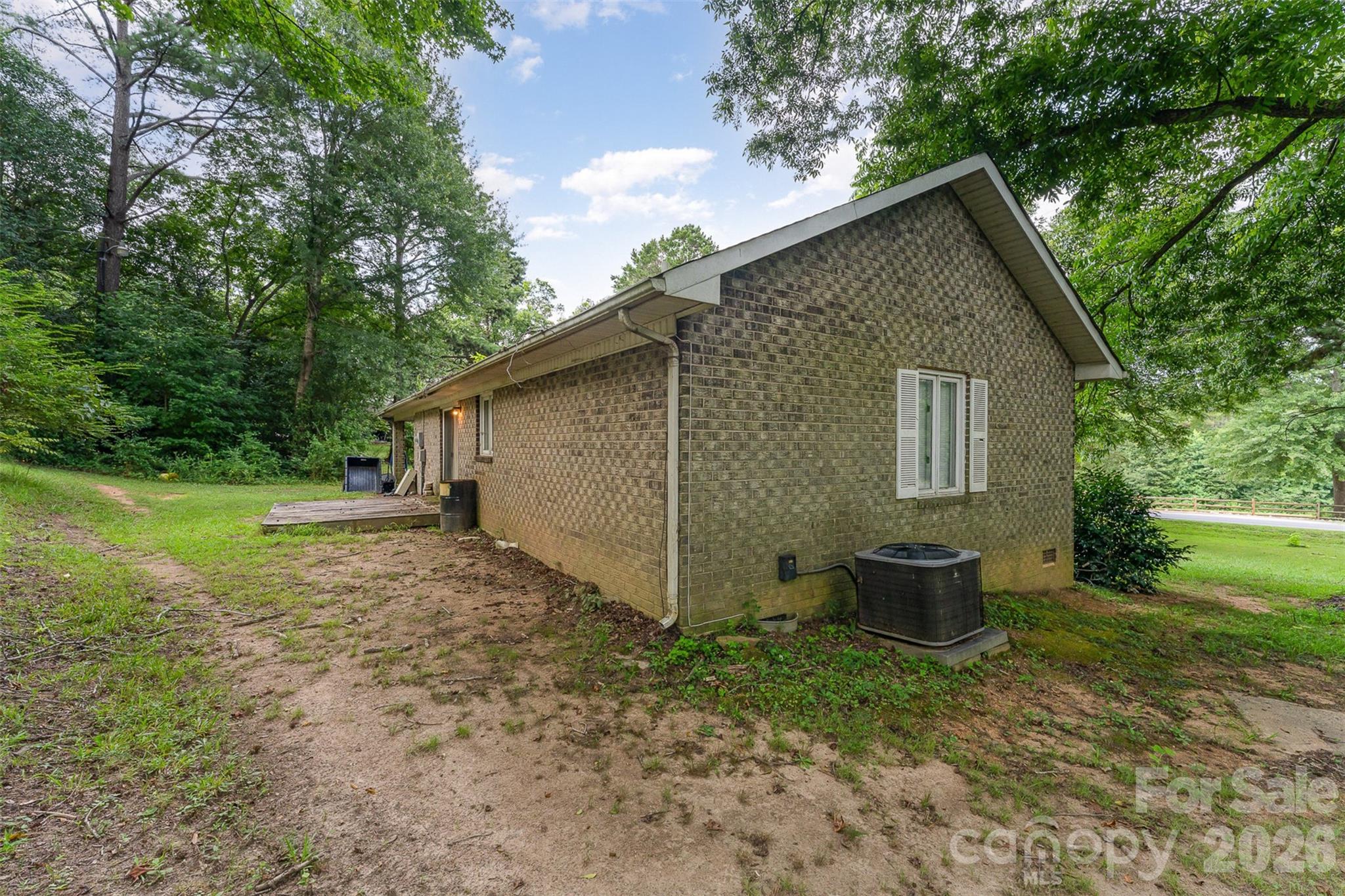 280 Dallas Spencer Mountain Road Gastonia, NC 28056 - Photo 13 of 19 a view of backyard of house with wooden deck and seating space