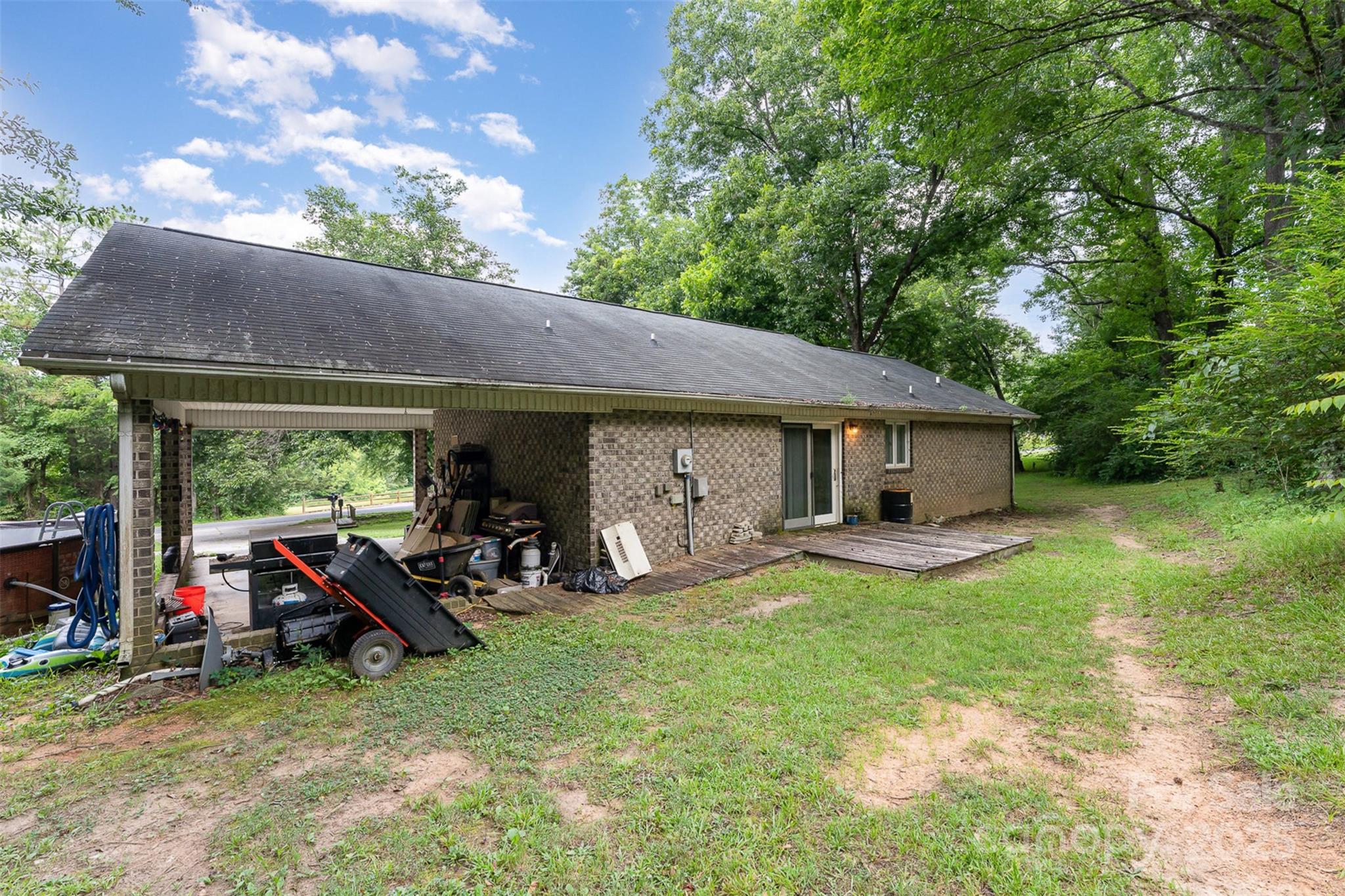 280 Dallas Spencer Mountain Road Gastonia, NC 28056 - Photo 15 of 19 a view of a house with backyard sitting area and garden