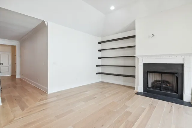 a view of a room with a fireplace and window