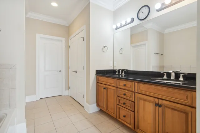 a spacious bathroom with a tub sink and mirror