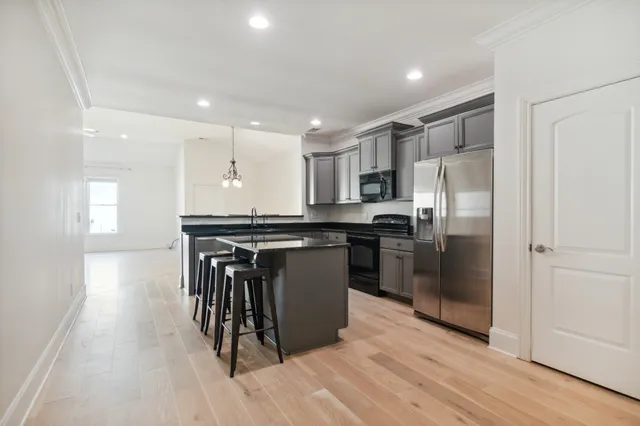 a kitchen with granite countertop a stove sink and cabinets