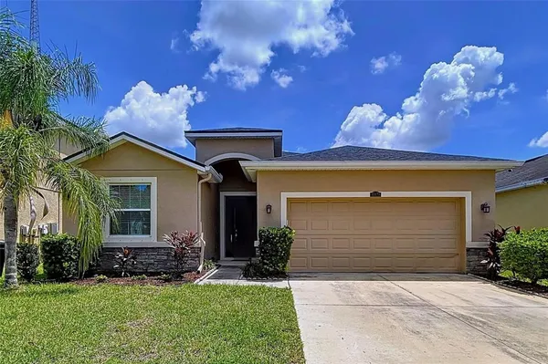 a living room with furniture a rug and a floor to ceiling window