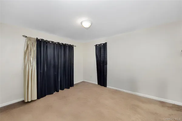 a view of an empty room with wooden walls