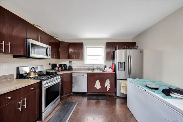 a kitchen with stainless steel appliances a refrigerator stove microwave and sink