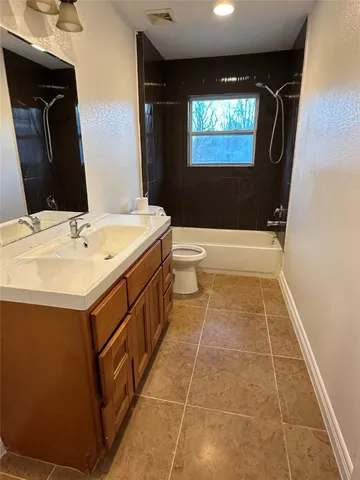 a bathroom with a sink a toilet and mirror