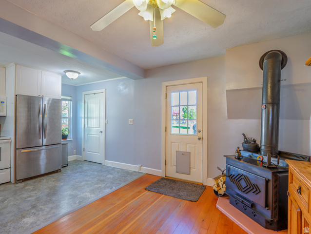 155 West Center Street Fillmore, UT 84631 - Photo 22 of 86 Wood-finish flooring and a corner wood-burning stove with a stone hearth