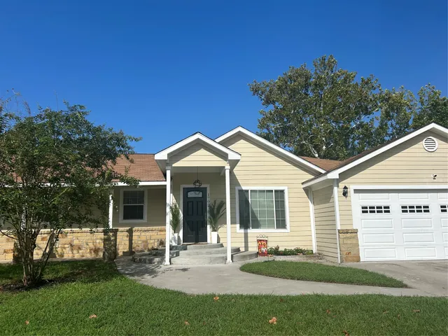 a front view of a house with a yard and porch
