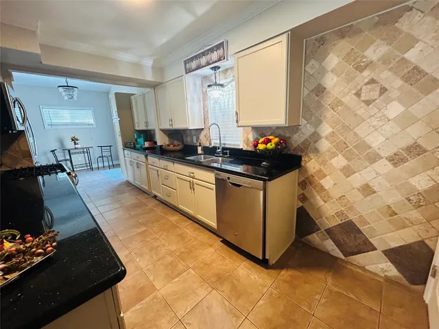 a kitchen with stainless steel appliances granite countertop a sink stove and cabinets