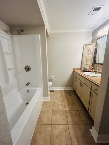 a bathroom with a double vanity sink toilet and a mirror