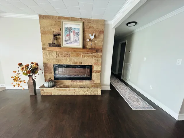a living room with furniture wooden floor and a fireplace