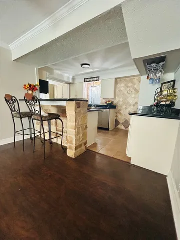 a living room with furniture and kitchen view