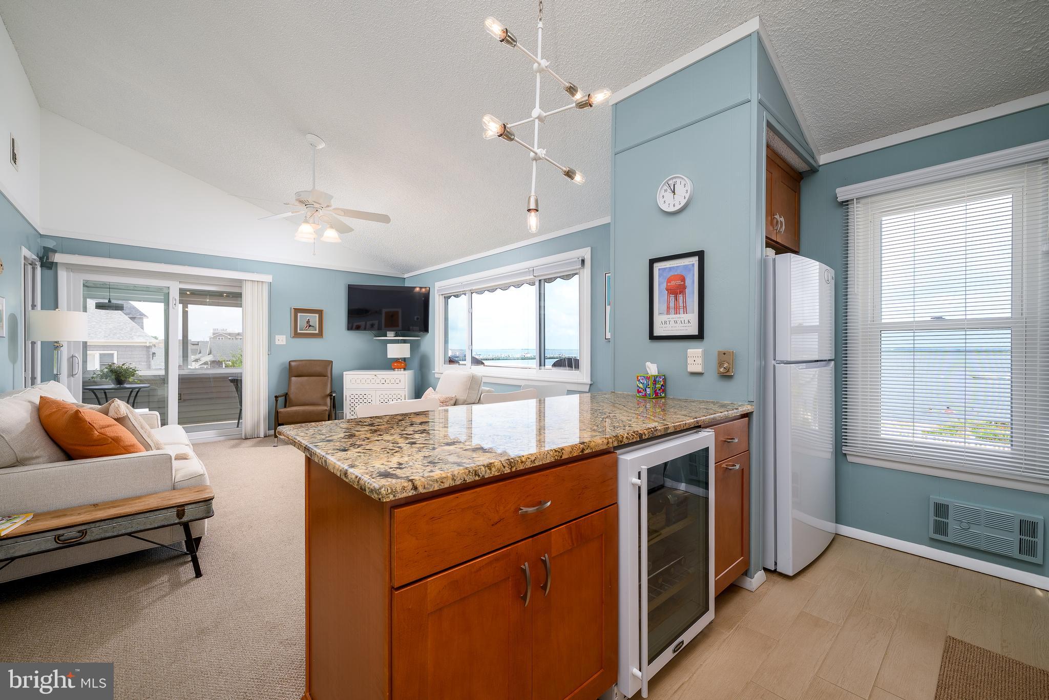 24 Joan Road Long Beach Township, NJ 08008 - Photo 11 of 66 a open kitchen with stainless steel appliances granite countertop a stove and a refrigerator