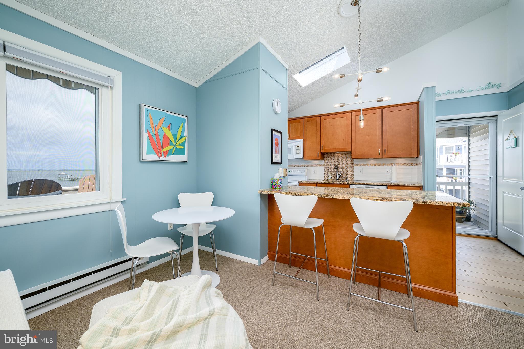 24 Joan Road Long Beach Township, NJ 08008 - Photo 14 of 66 a living room with furniture a window and kitchen view