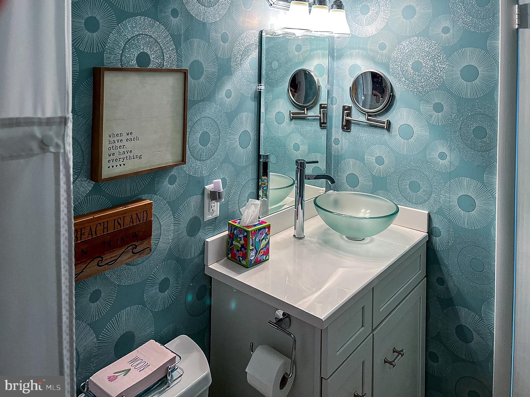 24 Joan Road Long Beach Township, NJ 08008 - Photo 25 of 66 a bathroom with a sink and a mirror