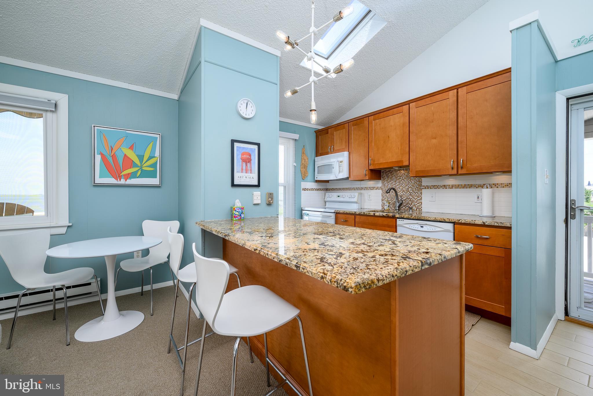 24 Joan Road Long Beach Township, NJ 08008 - Photo 10 of 66 a kitchen with a table and chairs in it