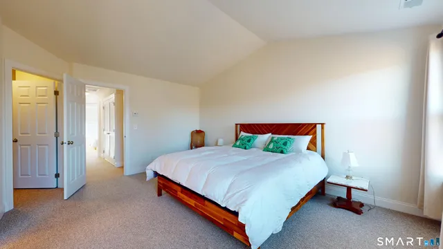 a bedroom with a bed and table