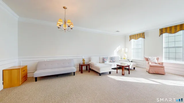 a living room with furniture and a chandelier