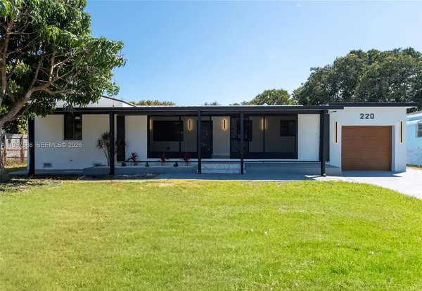 a view of a house with pool and a yard
