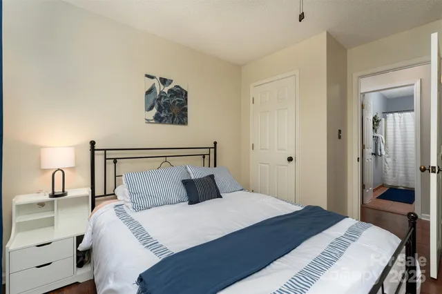 a bedroom with a bed and a mirror