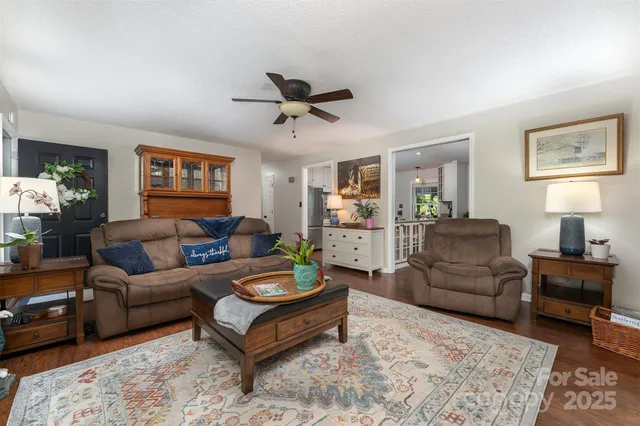 a living room with furniture and a ceiling fan