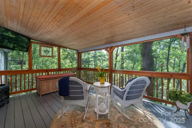 a view of a chair and tables in the balcony