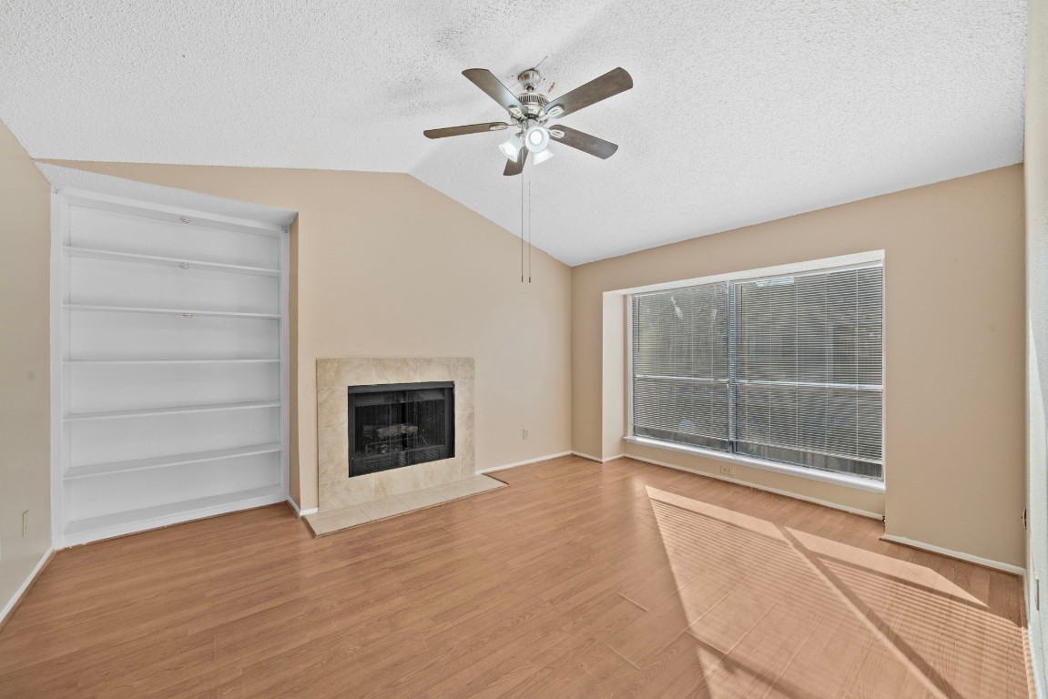 6701 Sands Point Drive, Unit 82 Houston, TX 77074 - Photo 3 of 23 a view of an empty room with a fireplace and a window