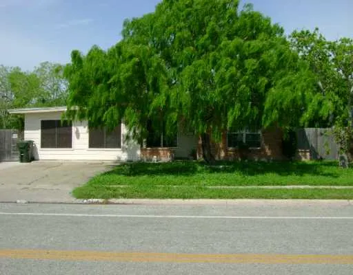 a front view of a house with a yard and a garage