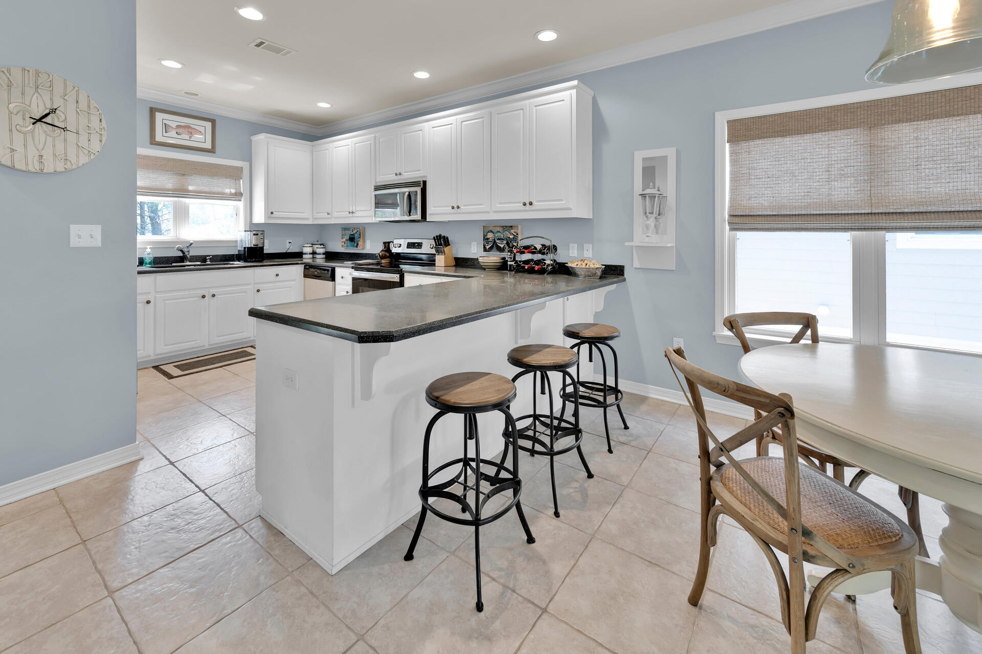 183 Hidden Lake Way Santa Rosa Beach, FL 32459 - Photo 7 of 50 a kitchen with stainless steel appliances granite countertop a table and chairs in it