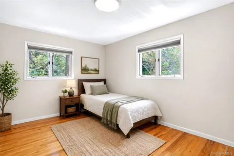 a bedroom with a bed lamp and a window