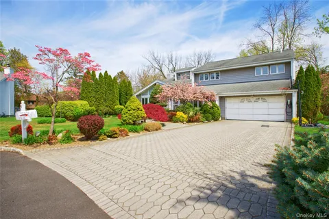 a front view of a house with a yard and a garage