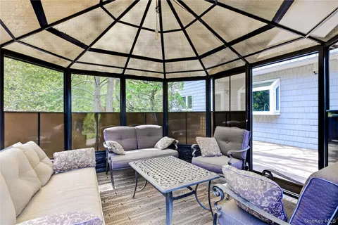 a living room with furniture and a floor to ceiling window