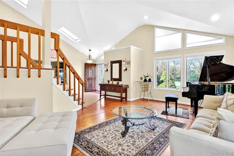 a living room with furniture a rug and a large window