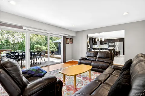 a living room with furniture and a floor to ceiling window