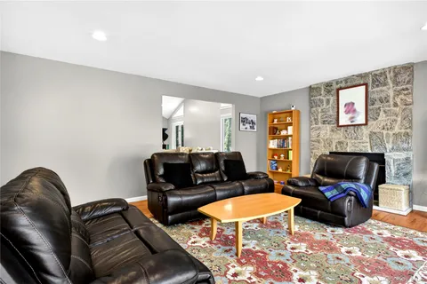 a living room with furniture a rug and a fireplace