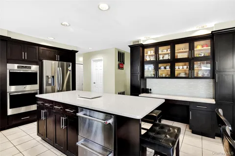 a kitchen with a stove a sink and a refrigerator