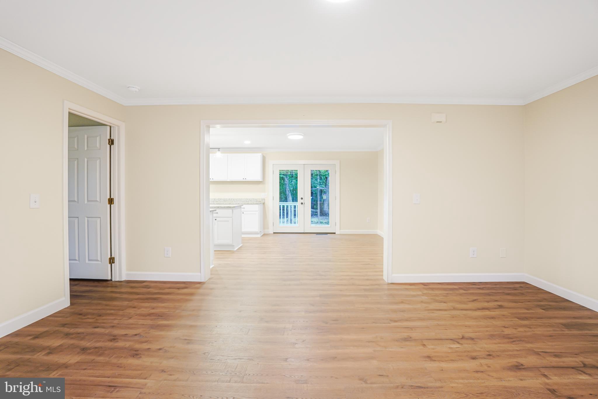767 Loving Road Zion Crossroads, VA 22942 - Photo 3 of 33 a view of an empty room with wooden floor and a window