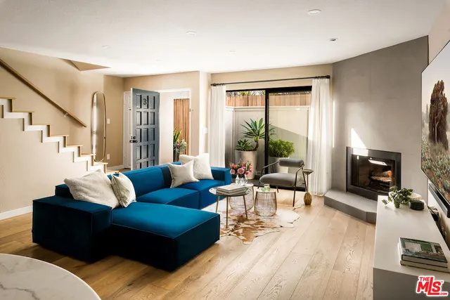 a living room with furniture large window and a flat screen tv