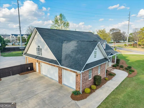an empty room with ceiling fan and windows