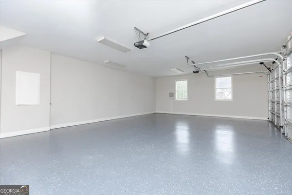 an empty room with ceiling fan and window