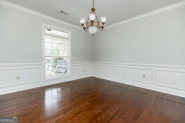 a front view of a house with yard and tree
