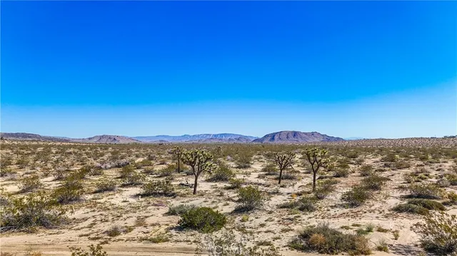 a view of a mountain range in a cloudy sky
