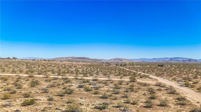 a view of a large mountain with mountains in the background