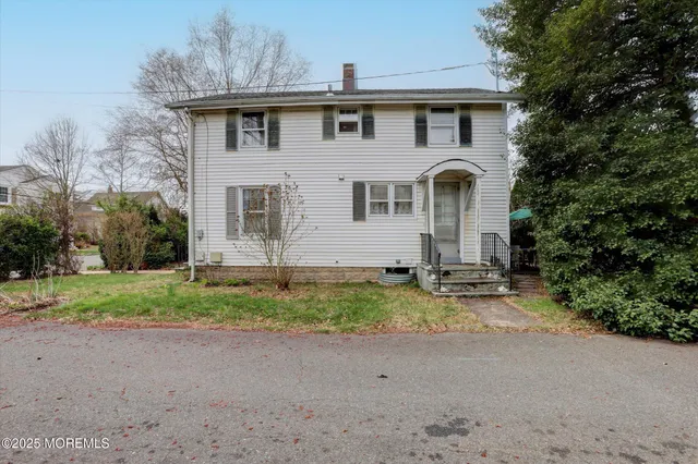 a view of a house with a yard and furniture